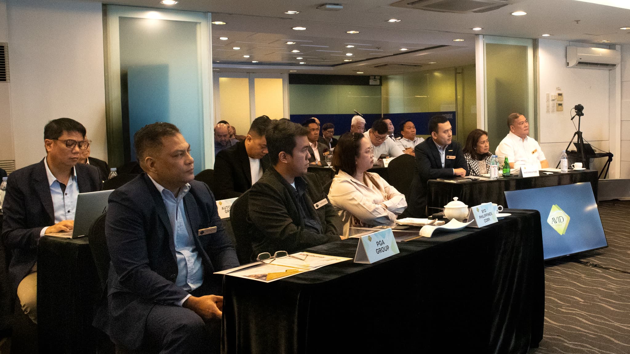 Automotive industry leaders attending an AVID forum